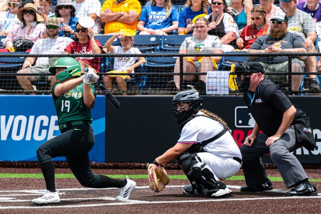 Softball player in green bats.