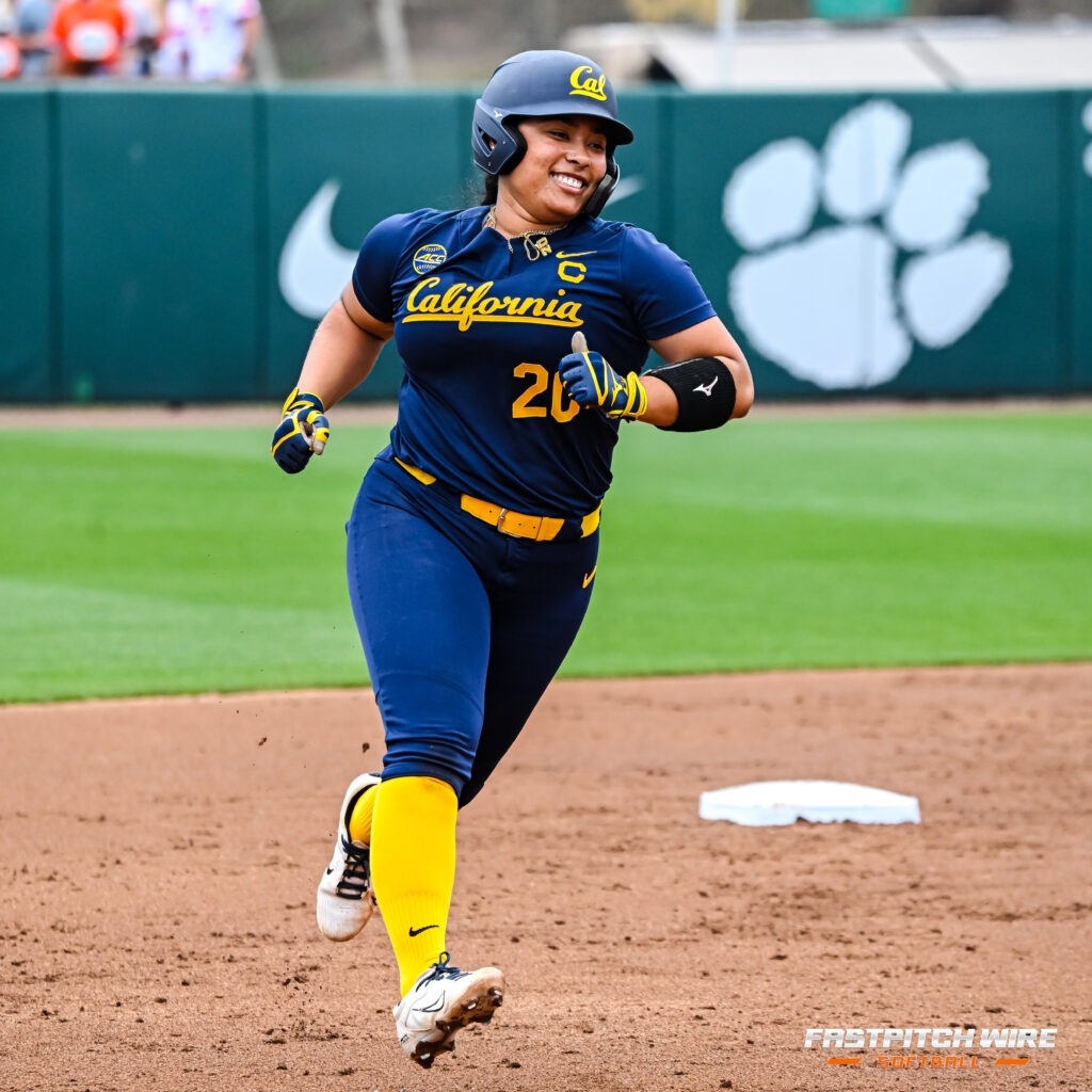 Tianna Bell in a Cal uniform smiling and running bases.